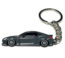 Load image into Gallery viewer, Car-shaped keychain on a white background Alternate Image