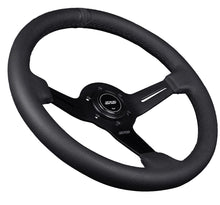 Load image into Gallery viewer, Black steering wheel with brand logo on a dark background Alternate Image