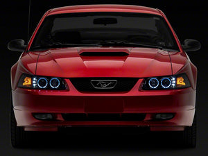 Raxiom Projector Headlights Ford Mustang SN95 (99-04) [Dual LED Halo] Black Housing/ Clear Lens