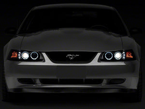 Raxiom Projector Headlights Ford Mustang SN95 (99-04) [Dual LED Halo] Chrome Housing/ Clear Lens or Black Housing/ Smoked Lens