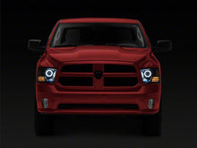 Load image into Gallery viewer, Raxiom Projector Headlights Dodge Ram 1500 Factory Halogen (09-18) Black Housing/ Clear Lens - Super White LED Halo Alternate Image