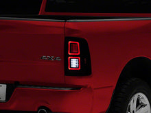 Load image into Gallery viewer, Raxiom Tail Lights Dodge Ram 1500 (09-18) [w/ Factory Halogen Lights] Black Housing / Smoked Lens Alternate Image