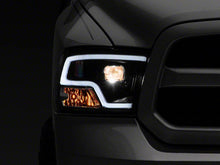 Load image into Gallery viewer, Raxiom Projector Headlights Dodge Ram 1500 Factory Halogen (09-18) Black Housing/ Clear Lens - Super White LED Halo Alternate Image