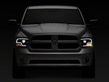 Load image into Gallery viewer, Raxiom Projector Headlights Dodge Ram 1500 Factory Halogen (09-18) Black Housing/ Clear Lens - Super White LED Halo Alternate Image