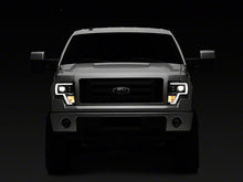 Load image into Gallery viewer, Raxiom Projector Headlights Ford F150 Factory Halogen (09-14) Black Housing/ Clear Lens Alternate Image